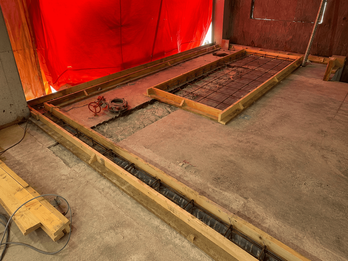 Completed concrete and service preparation work inside an industrial facility